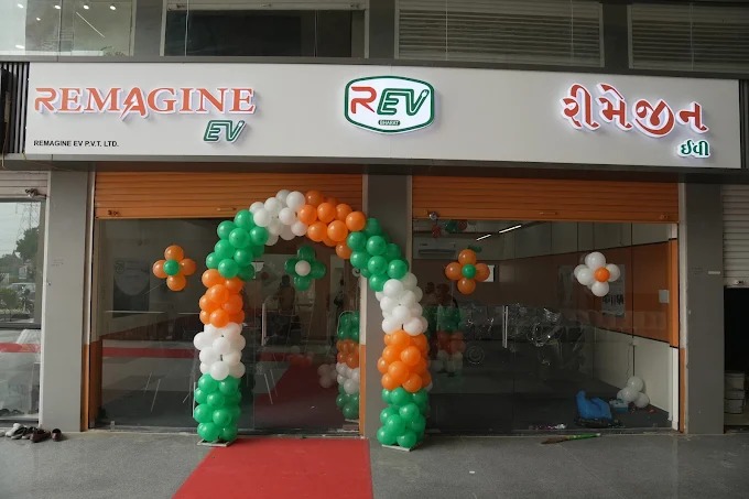REV Bharat showroom entrance with green, white and orange balloon arch